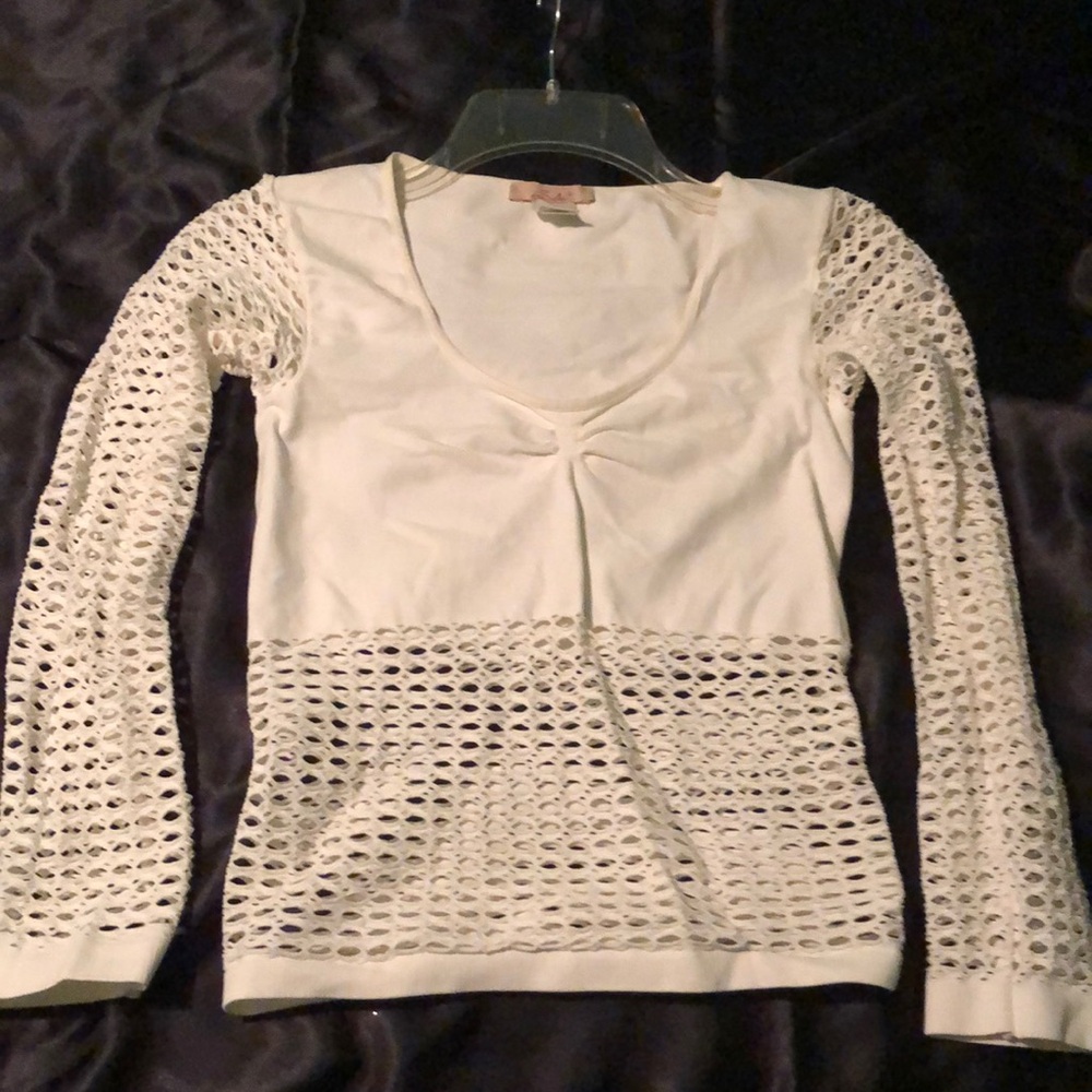 White stretch top with mesh long sleeves and bottom mesh.
